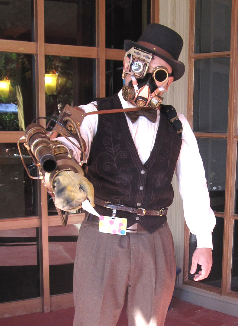 Man posed in steampunk garb.
